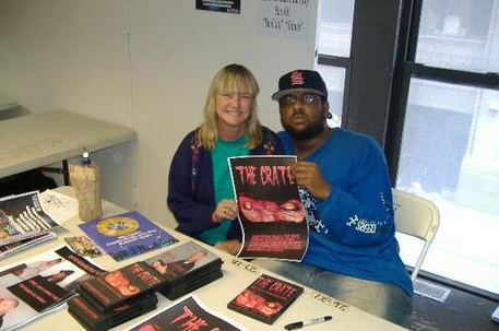 Donna Gray and Rakeem JH Lawrence at a horror convention with The Crate poster